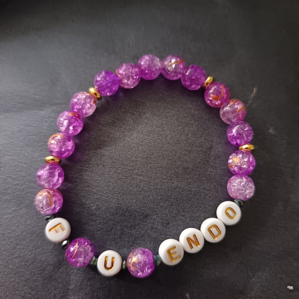 Elasticated purple beaded endometriosis letter bracelet