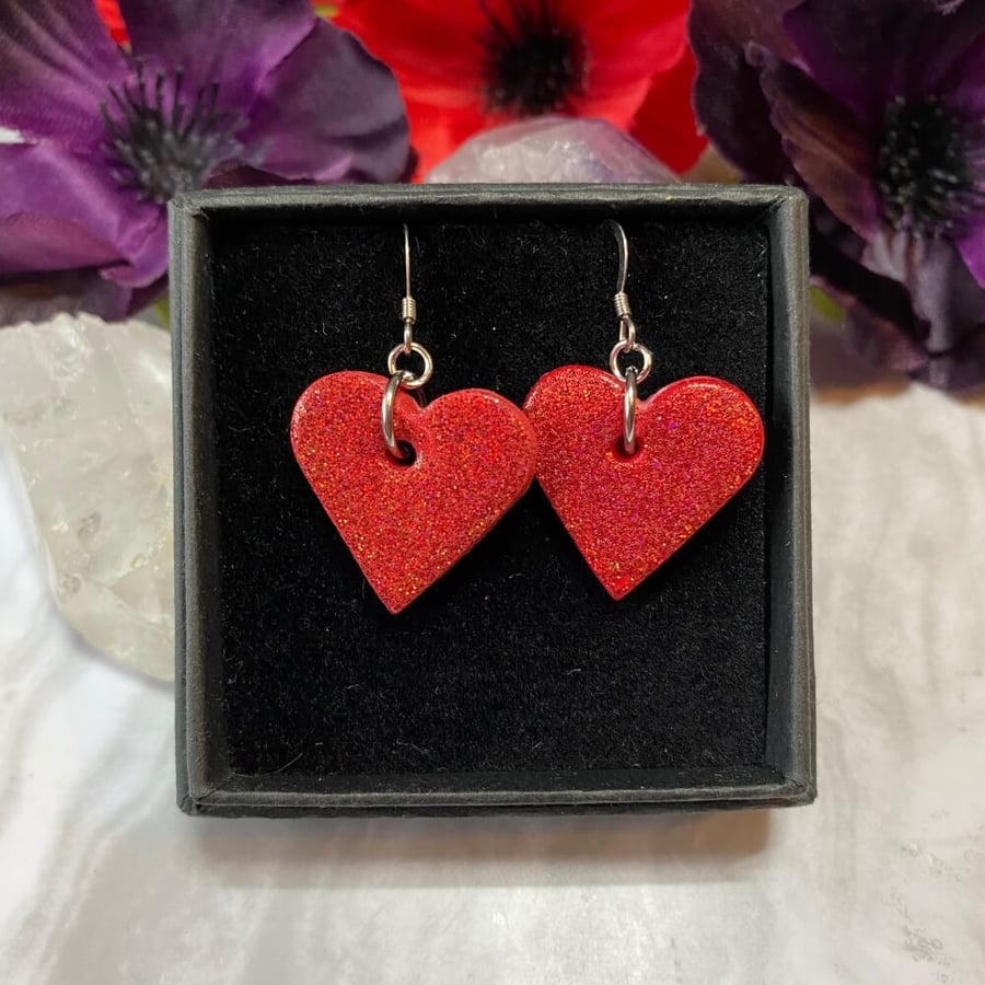 Red heart glitter earrings on sterling silver ear wires.