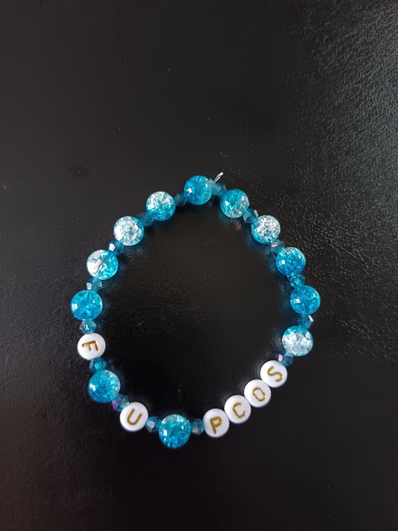 Elasticated PCOS  awareness bracelet with blue glass beads 