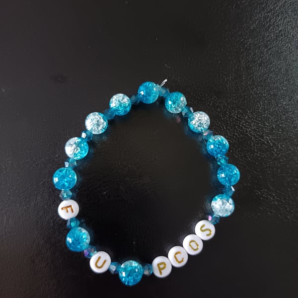Elasticated PCOS  awareness bracelet with blue glass beads 