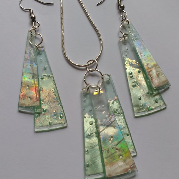 Matched set of earrings and a pendant. Silver and reflective green.
