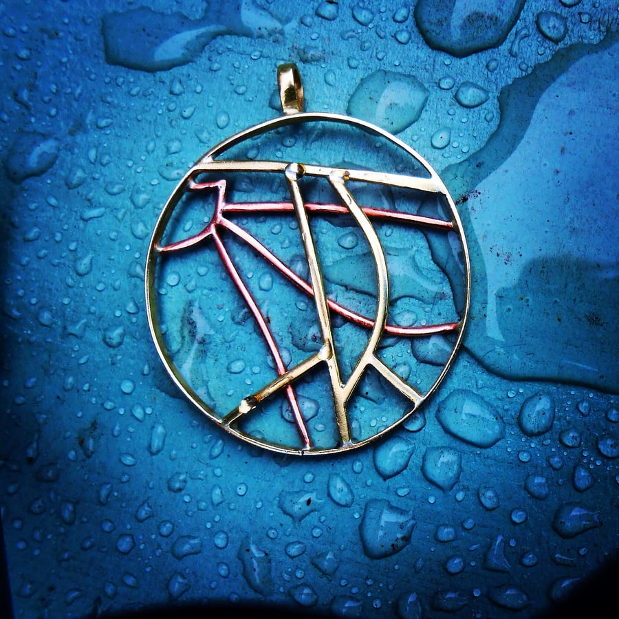 A pendant from a child's scribble. Designed from a child's drawing.