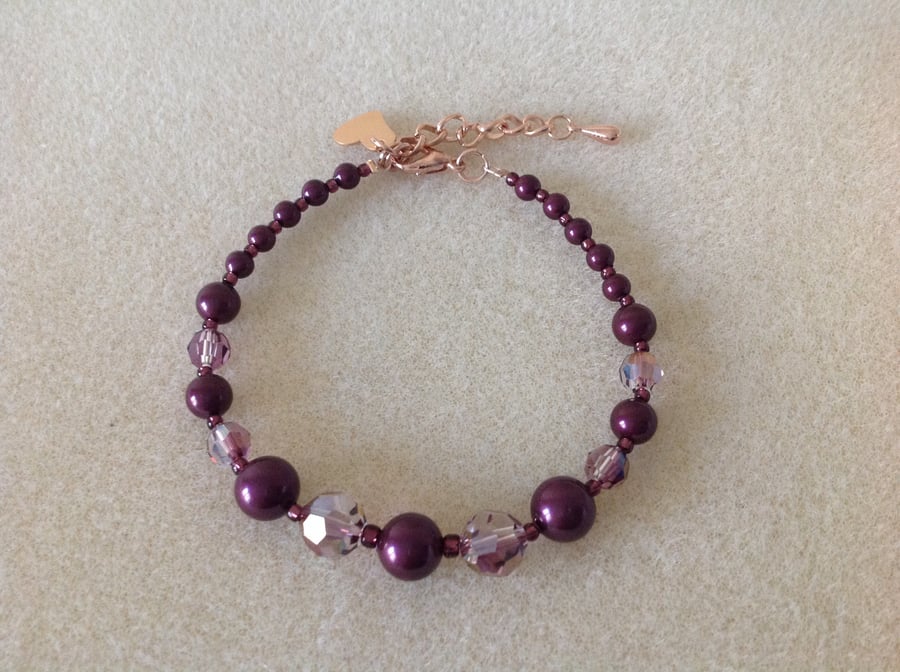 Blackberry maroon pearl and crystal rose gold heart charm bracelet.