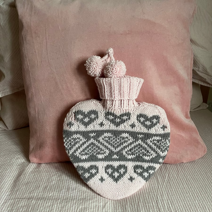 Heart shaped hot water bottle with hand knit cover
