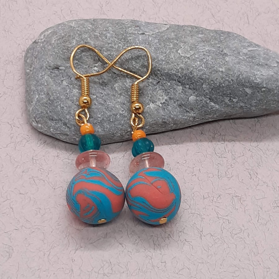 Turquoise and orange dangly earrings