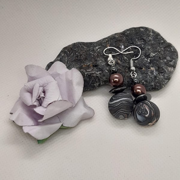 Polymer clay dangly earrings in black, white and sienna