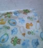 Babies Dribble Bib with Bottles, Bibs and Bootees in Blue on a Cream Background - Image 3