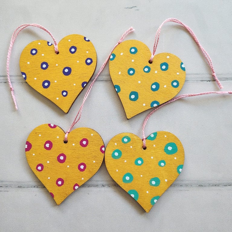Whimsical hand painted gold hearts hanging decoration with polka dots