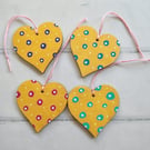 Whimsical hand painted gold hearts hanging decoration with polka dots