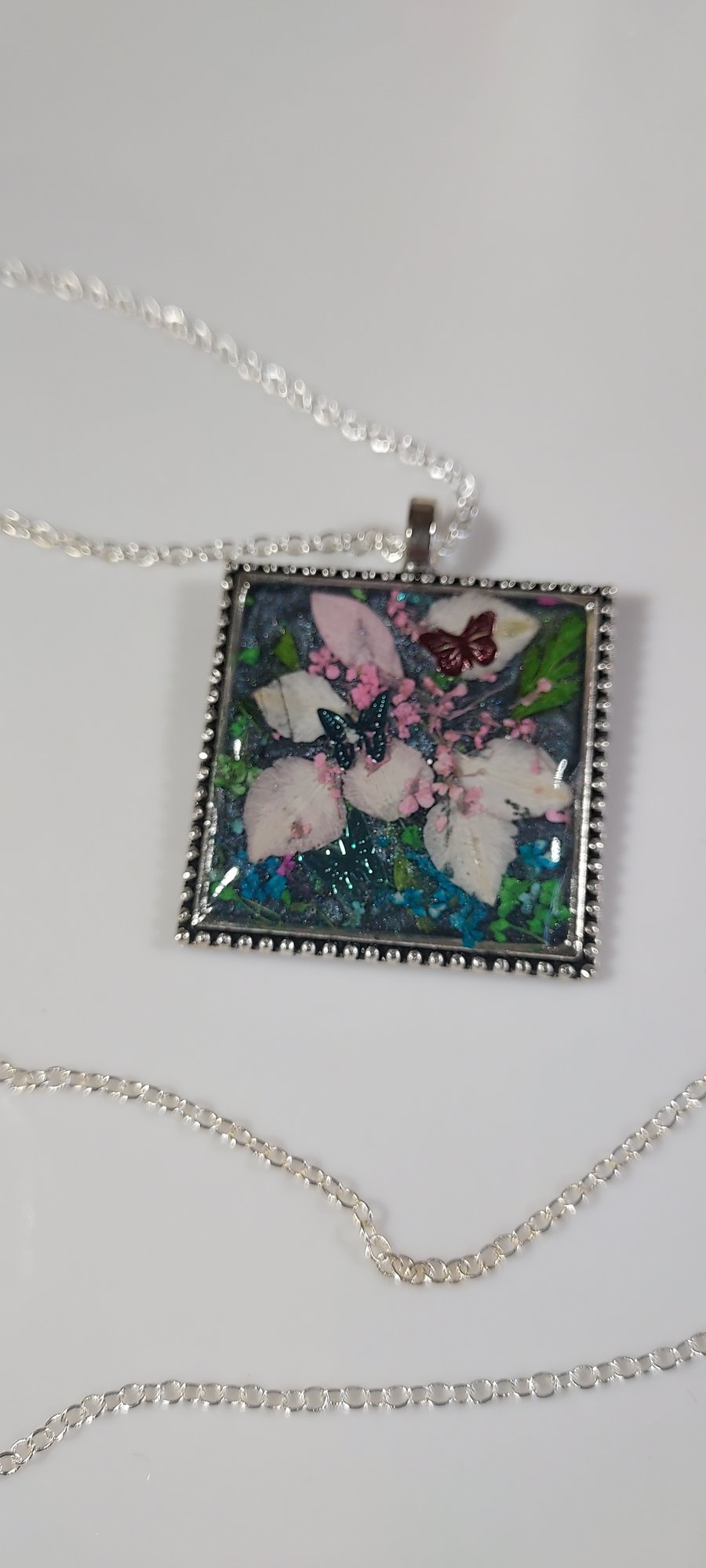 Square pendant necklace with real dried flowers in resin. 