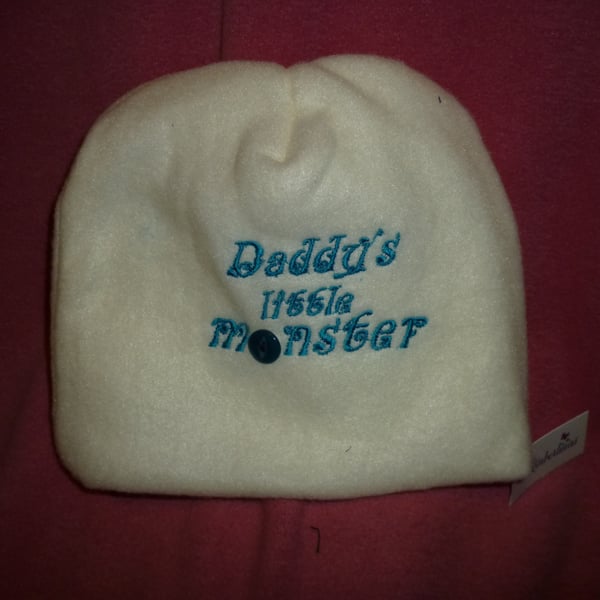 Hand made sewn baby hat in soft fleece fabric -cream with turquoise writing