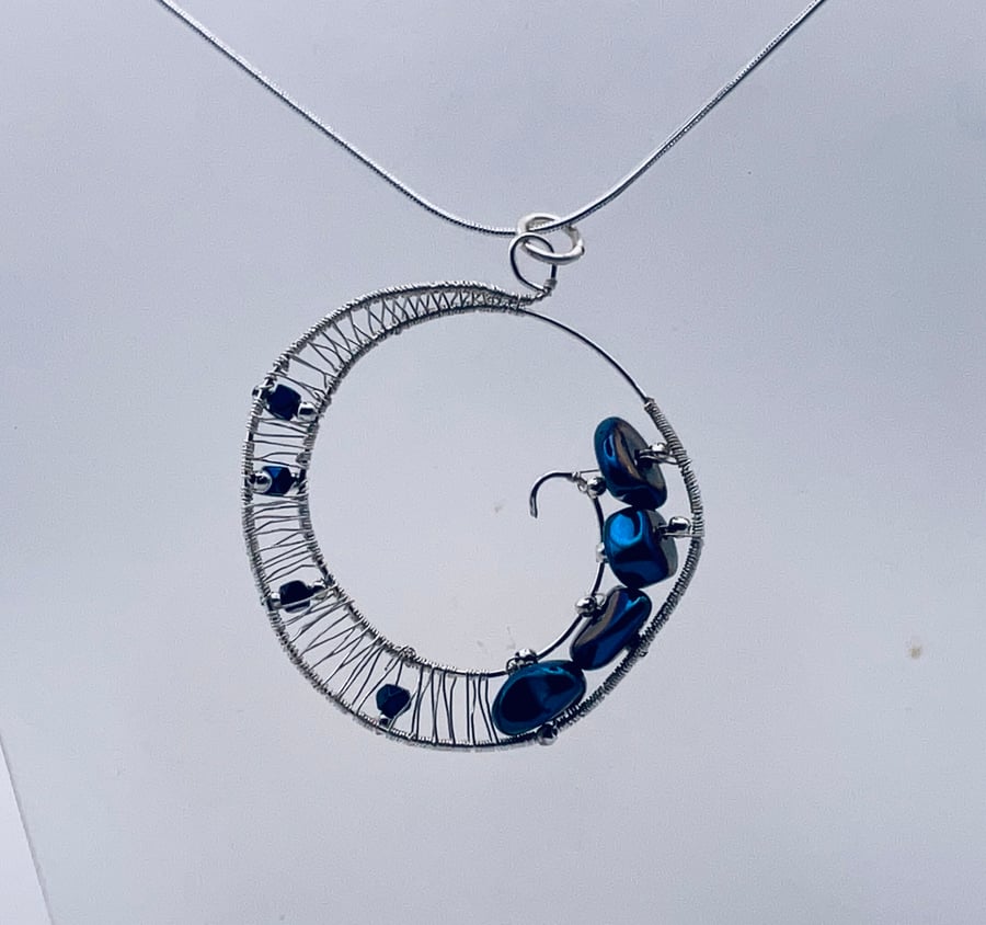 Sparkling midnight blue hematite halo pendant