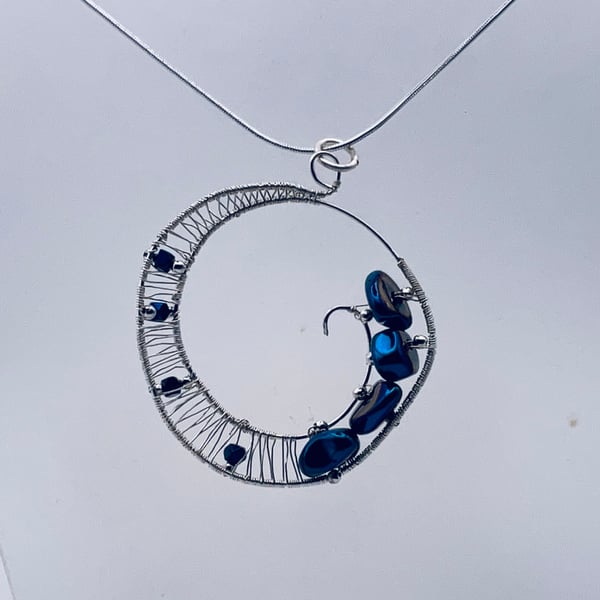 Sparkling midnight blue hematite halo pendant