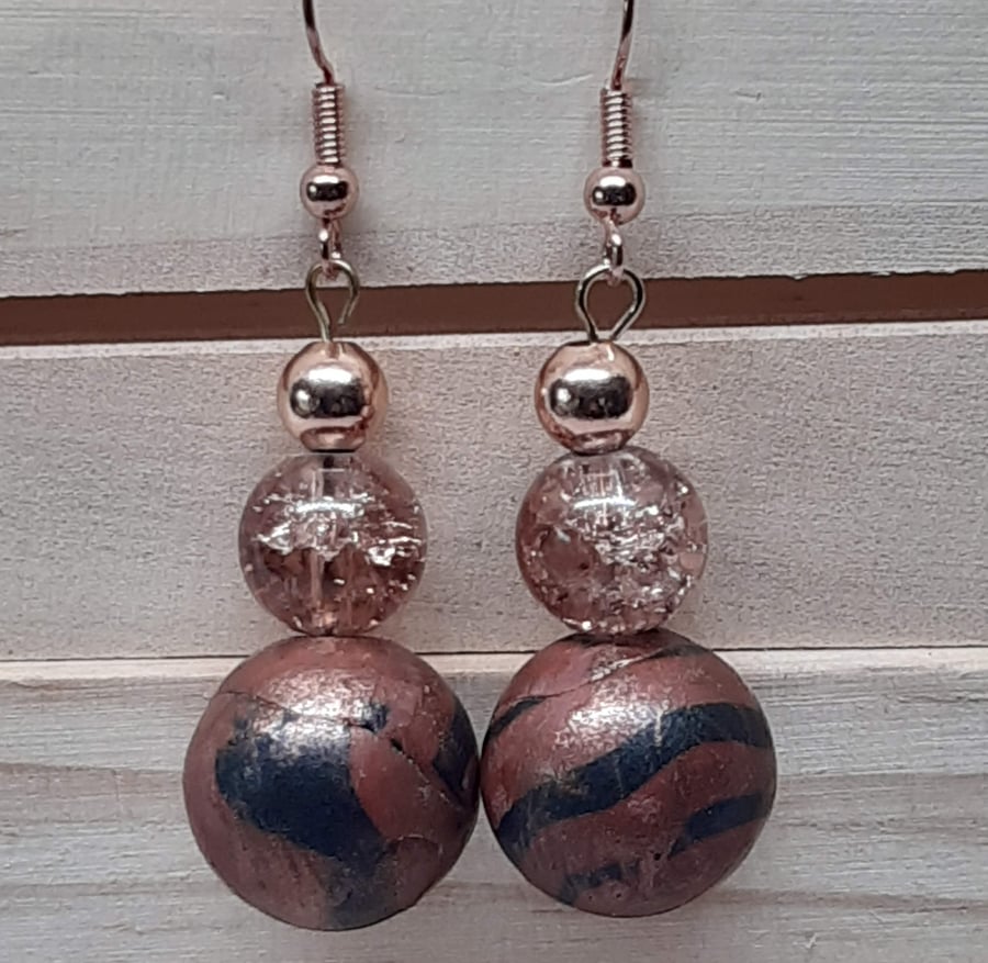 Conker brown and black dangly earrings with a bronze sheen