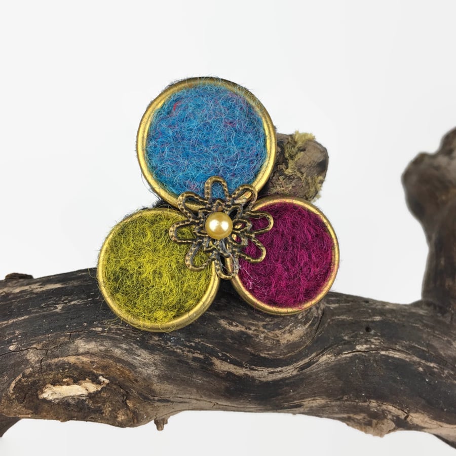 Needle felted brass circle brooch with floral centre