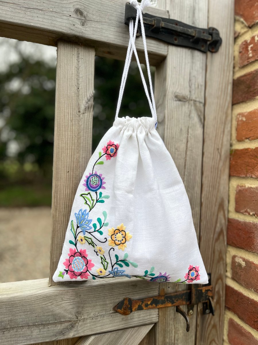 Embroidered linen drawstring bag with striped cotton back