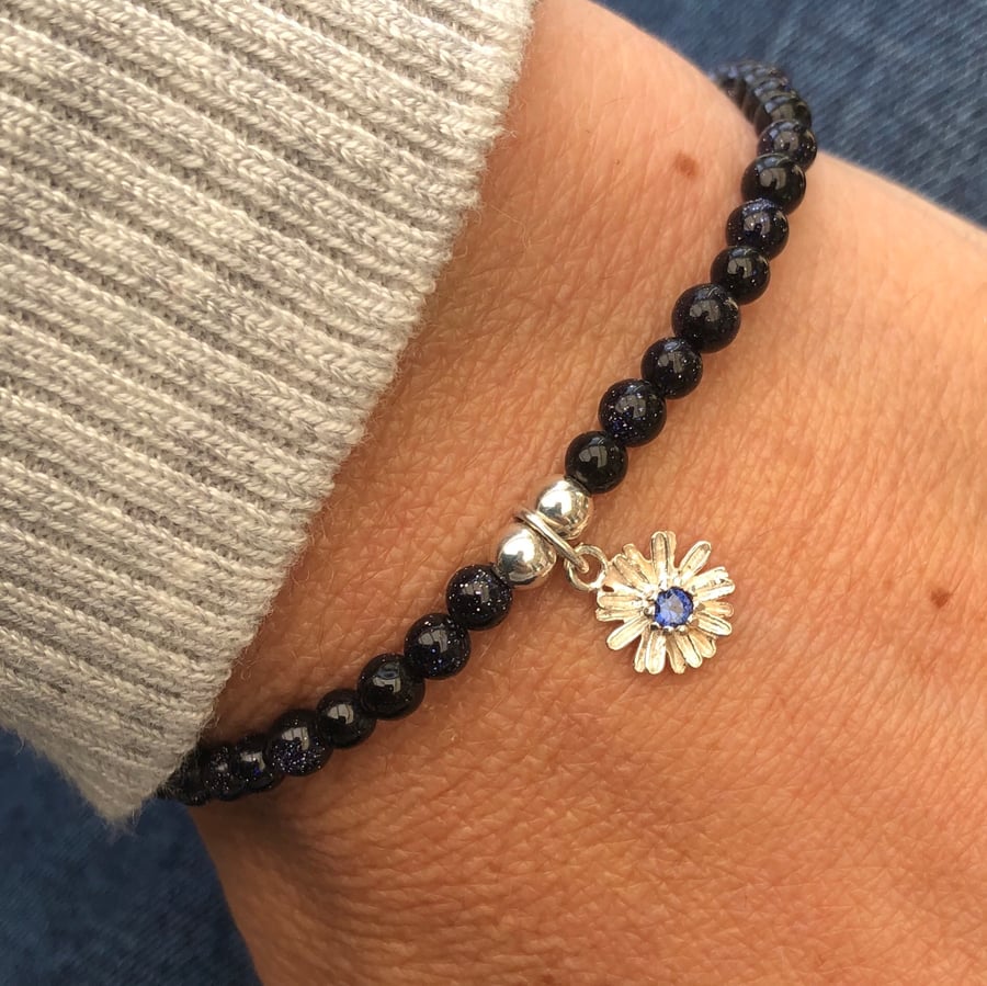 Blue Goldstone beaded bracelet with flower charm