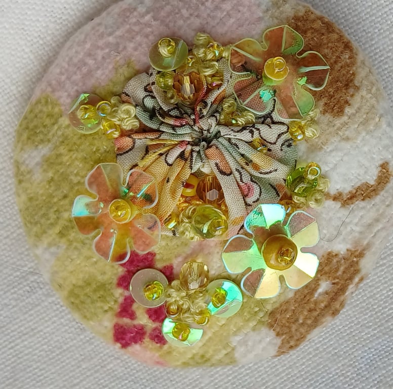 The pastel yellow brooch with sequins and beads