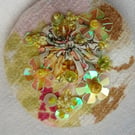 The pastel yellow brooch with sequins and beads
