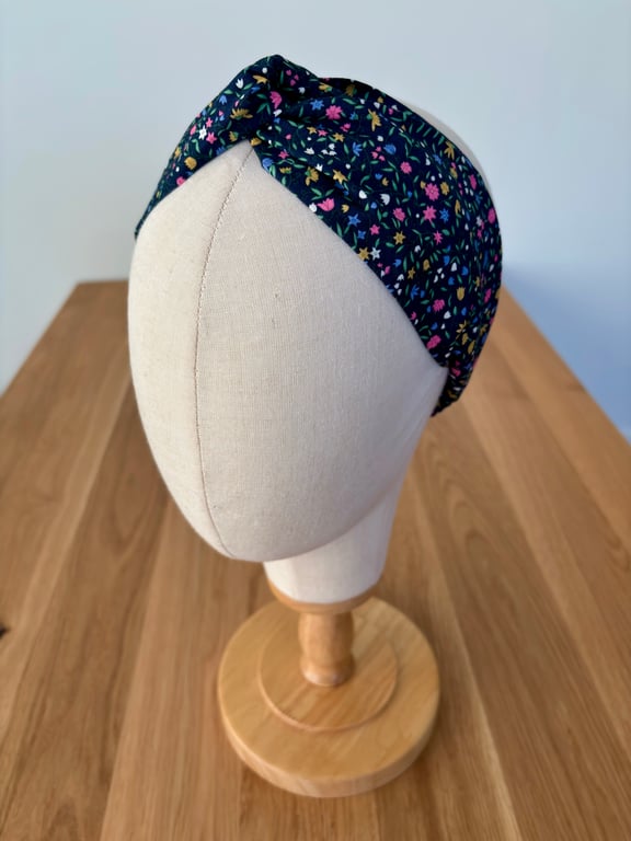 Cotton headband, twist knot style hairband in navy with bright flowers.