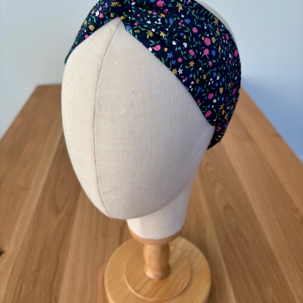 Cotton headband, twist knot style hairband in navy with bright flowers.