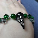 Gothic Bird skull charm bracelet with green beads. Gift boxed. 