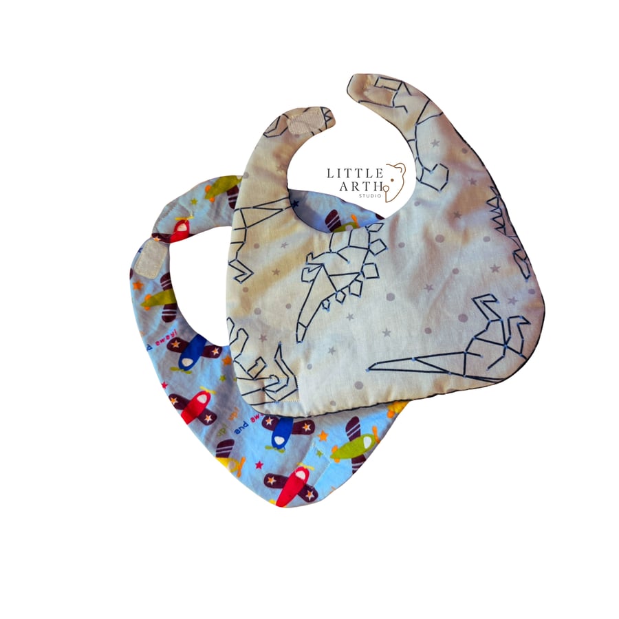 TWO double-sided bibs, dinosaurs and planes