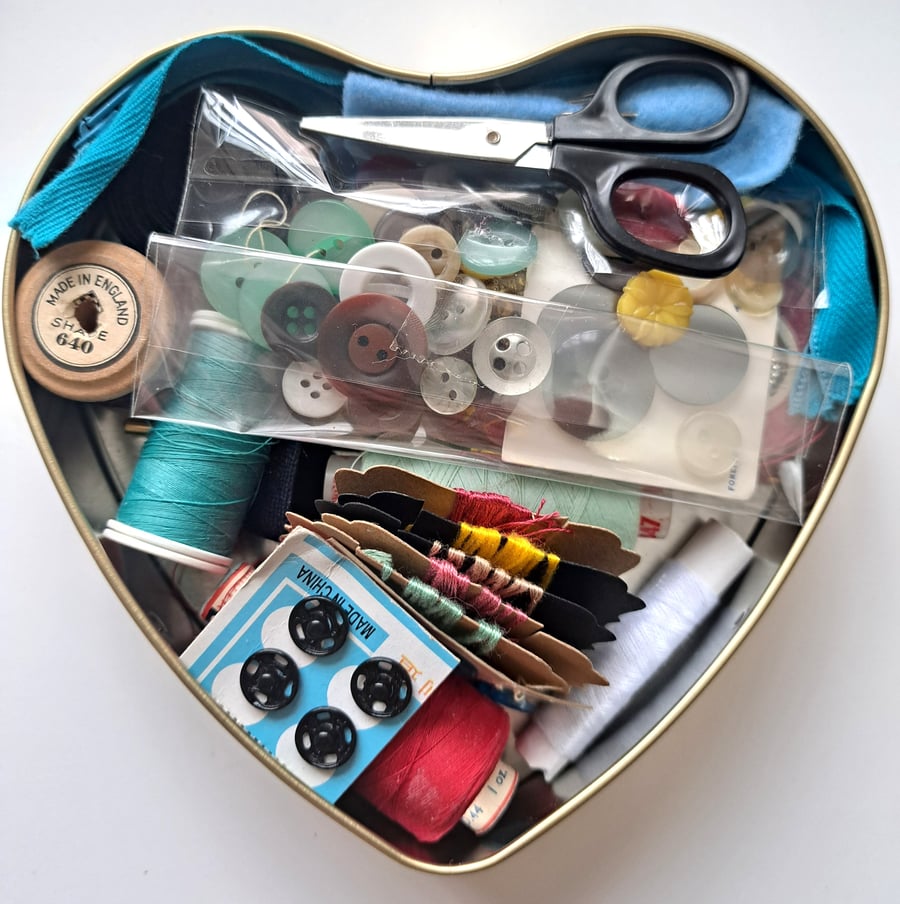 Vintage sewing haberdashery kit in an old heart shaped tin