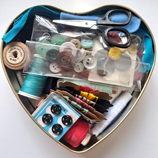 Vintage sewing haberdashery kit in an old heart shaped tin