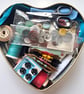 Vintage sewing haberdashery kit in an old heart shaped tin