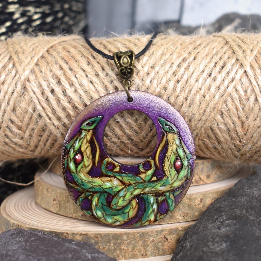 The holly dragons. Hand burned and coloured Pyrography pendant.