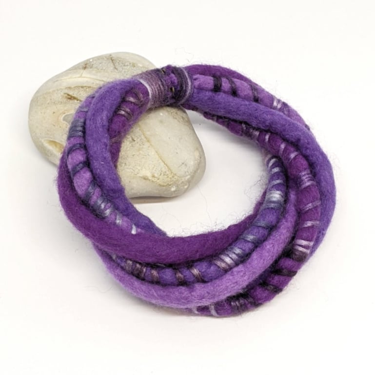 Felted cord bracelet in shades of purple