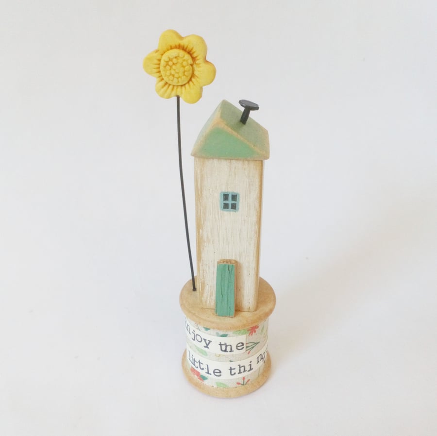 Little house with clay flower on vintage bobbin 'enjoy the little things'