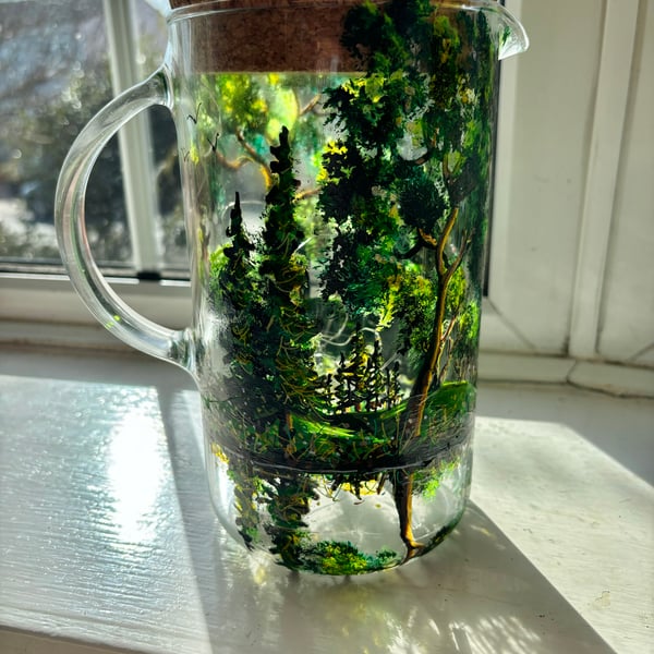 A glass hand painted and fired pitcher with lid by Andrew Jenkins 