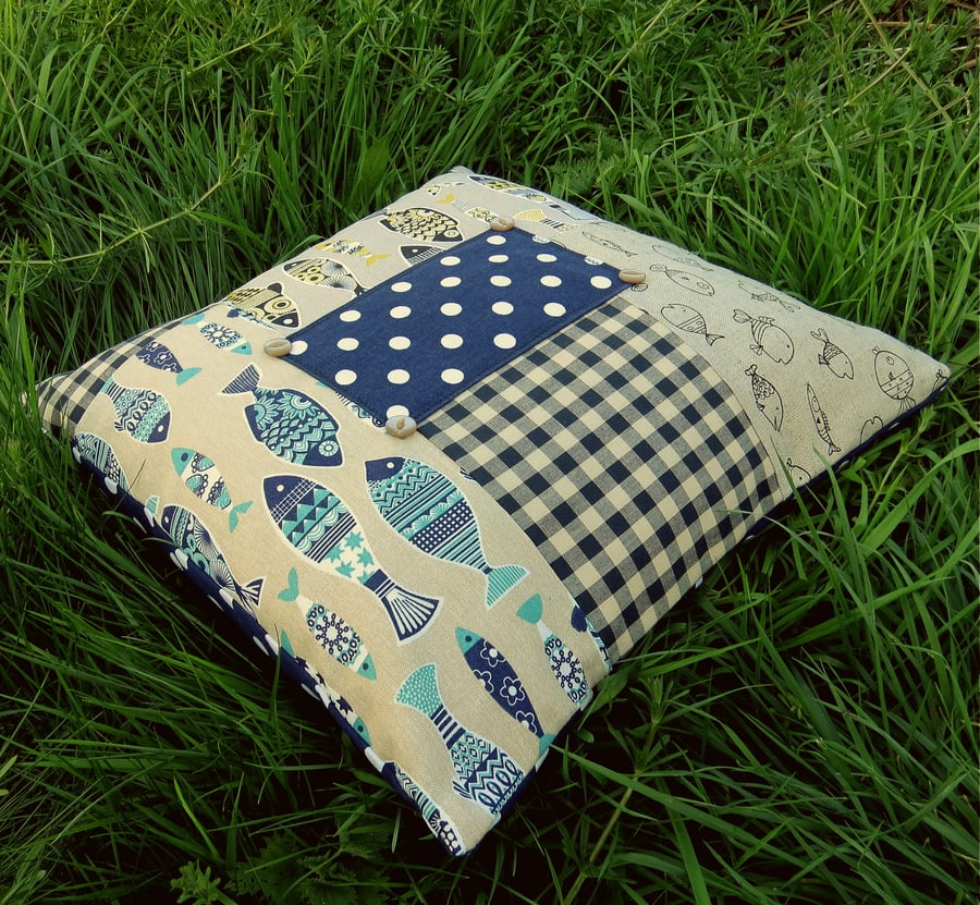 A patchwork floor cushion.  51cm x 51cm.  With feather pad.