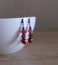 RED AND ANTIQUE BRONZE EARRINGS. - Image 2