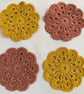 Set of 4 crochet coasters in terracotta and gold