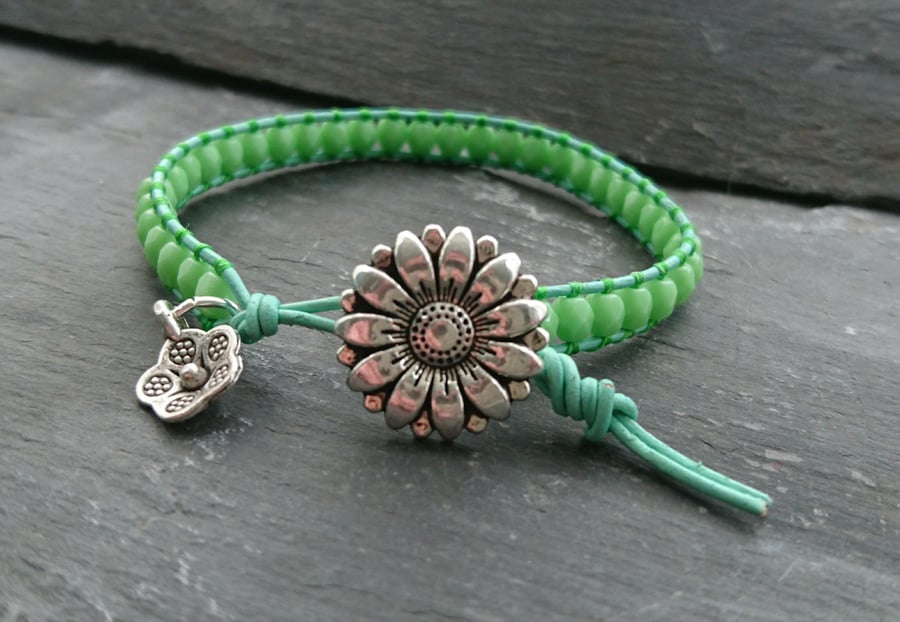 Green leather and glass bead bracelet with flower button and charm