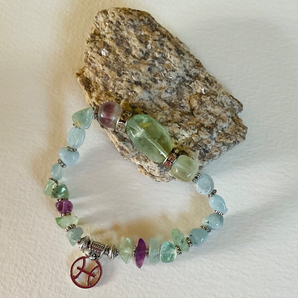 Pisces March birthday charm bracelet featuring aquamarine beads