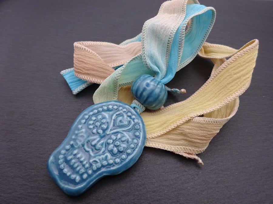 ceramic skull pendant, hand dyed silk ribbon necklace