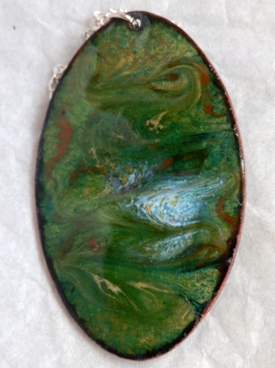 red, white and yellow enamel scrolled on green over clear - long oval pendant