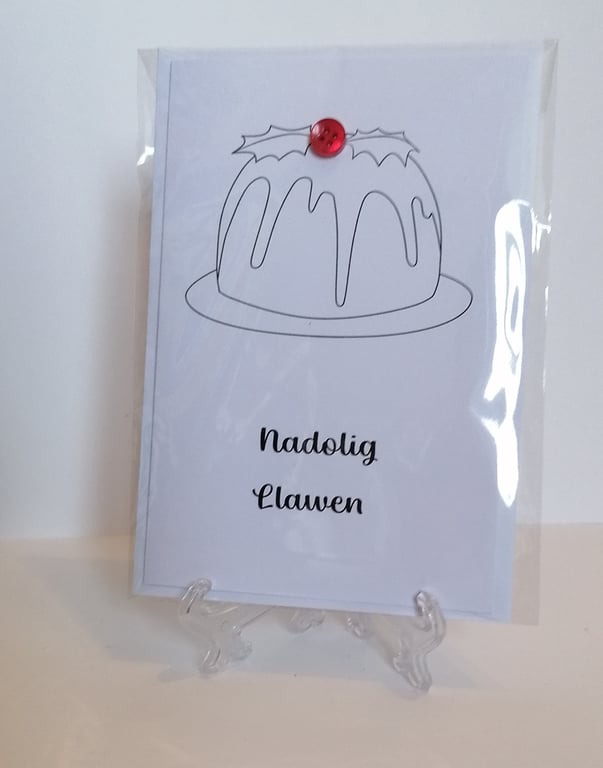 Nadolig Llawen Welsh Christmas card with a red button on a Christmas pudding