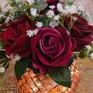 Beautiful faceted glass bowl of roses in rich red