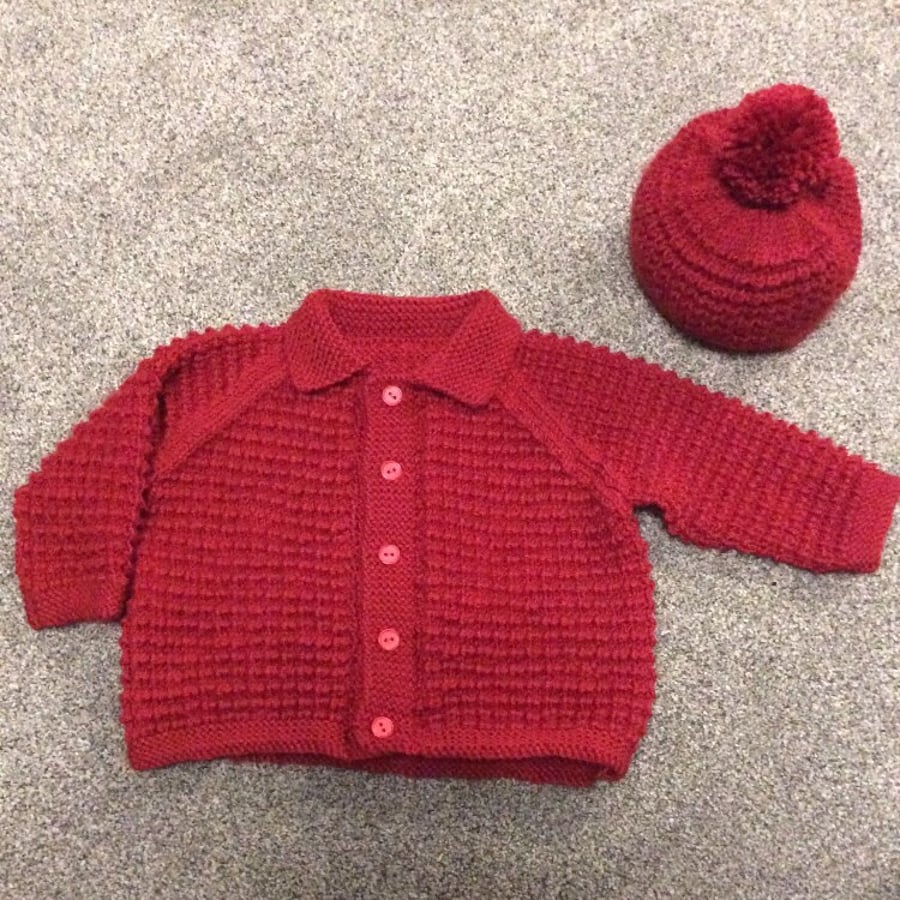 Red chunky knit cardigan with bobble hat