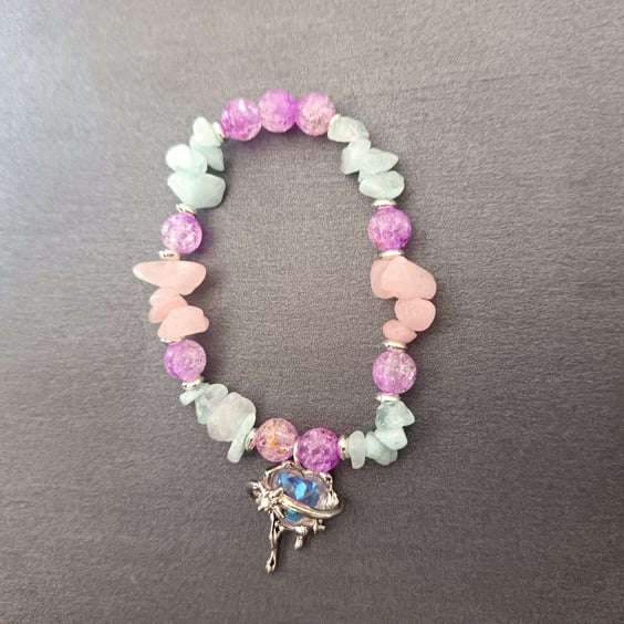 Elasticated beaded pastel coloured bracelet with heart and star charm 