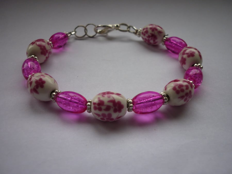 DEEP PINK, WHITE AND SILVER, FLORAL CERAMIC BEAD BRACELET.