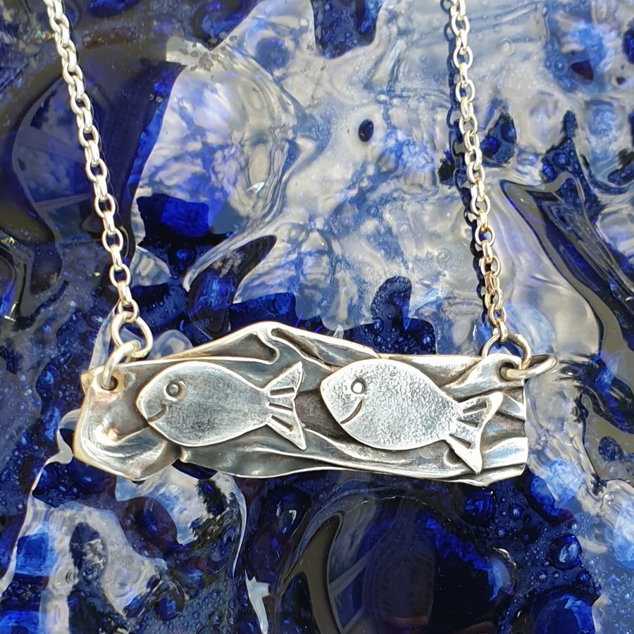 Swimming fish pendant