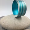 Turquoise and grey anodised aluminium striped cuff