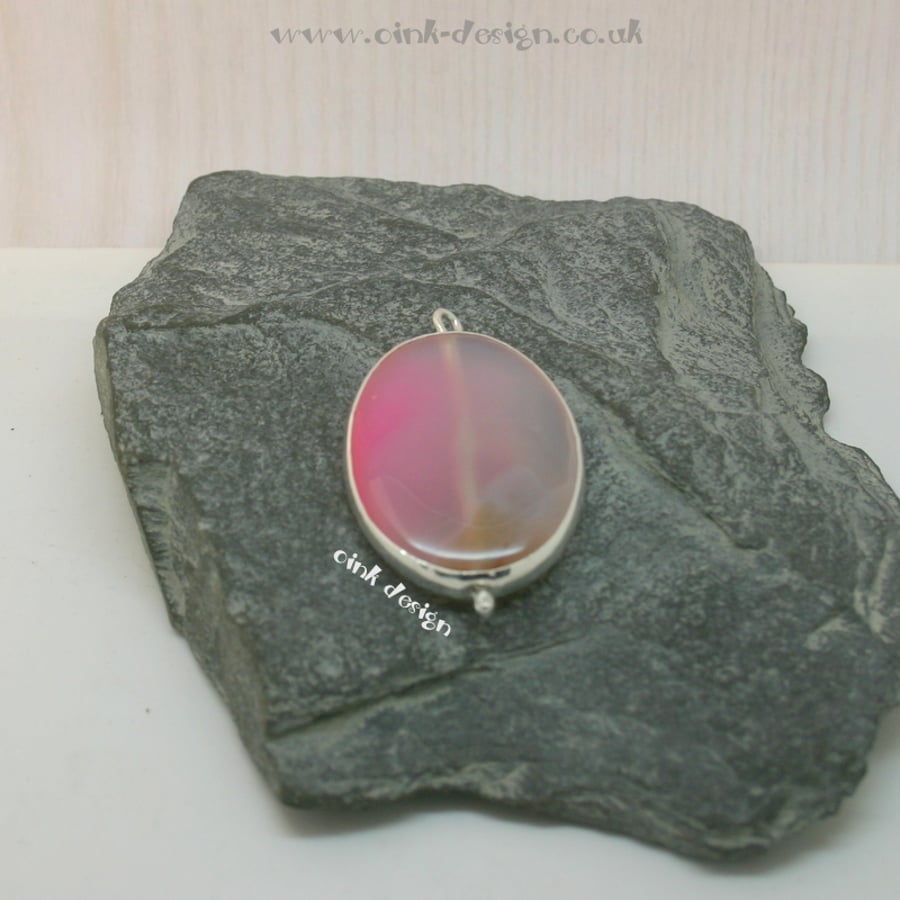 A slice of pale pink agate set in sterling silver