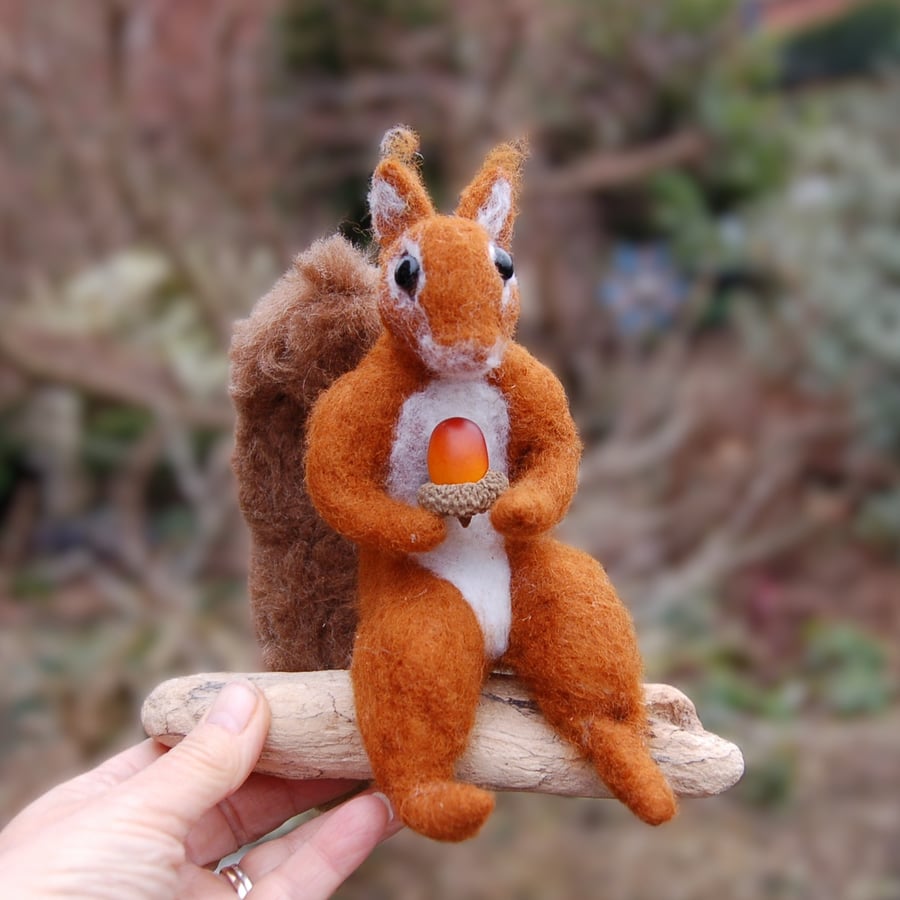 Squirrel displayed on driftwood    -  Wool needlefelt.   6 ins tall.